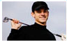 Smiling adult man holding golf club – routine eye exams and vision care for adults at Medical Eye Associates