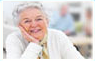 Smiling senior woman resting her hand on chin – routine and specialty eye care services for seniors at Medical Eye Associates